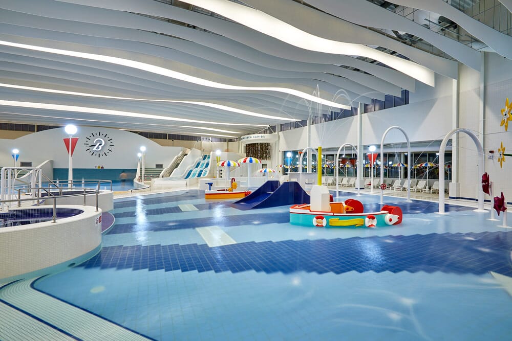 Swimming pool with acoustic baffles on ceiling