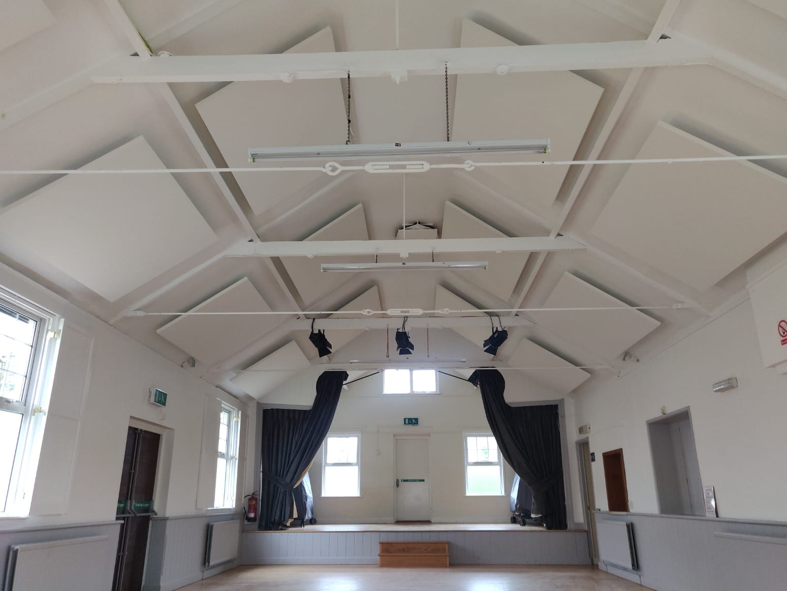 Village hall with acoustic panels on ceiling
