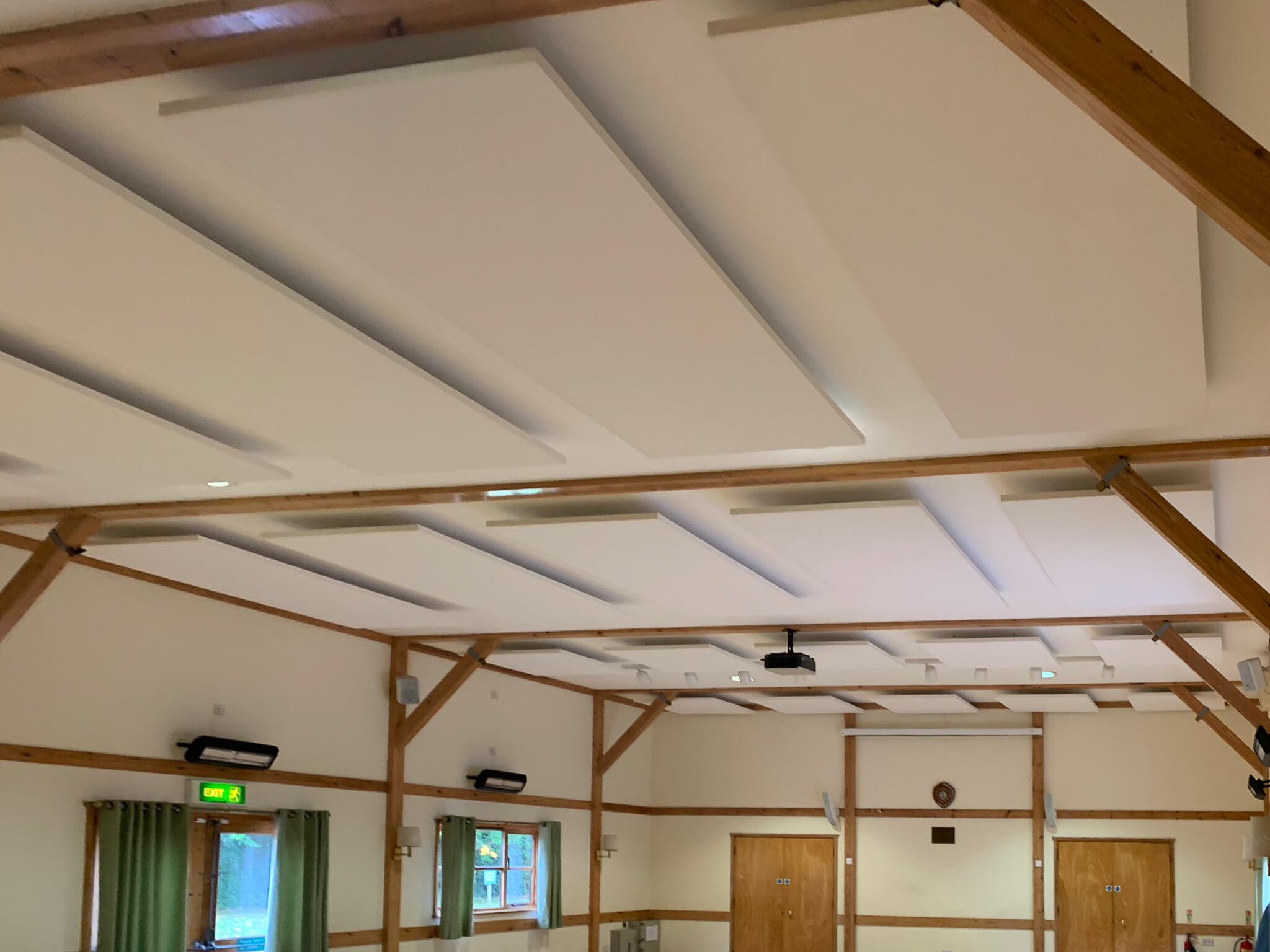 Acoustic panels installed on the ceiling at Lower Hardres Village Hall, reducing echo and improving speech clarity.