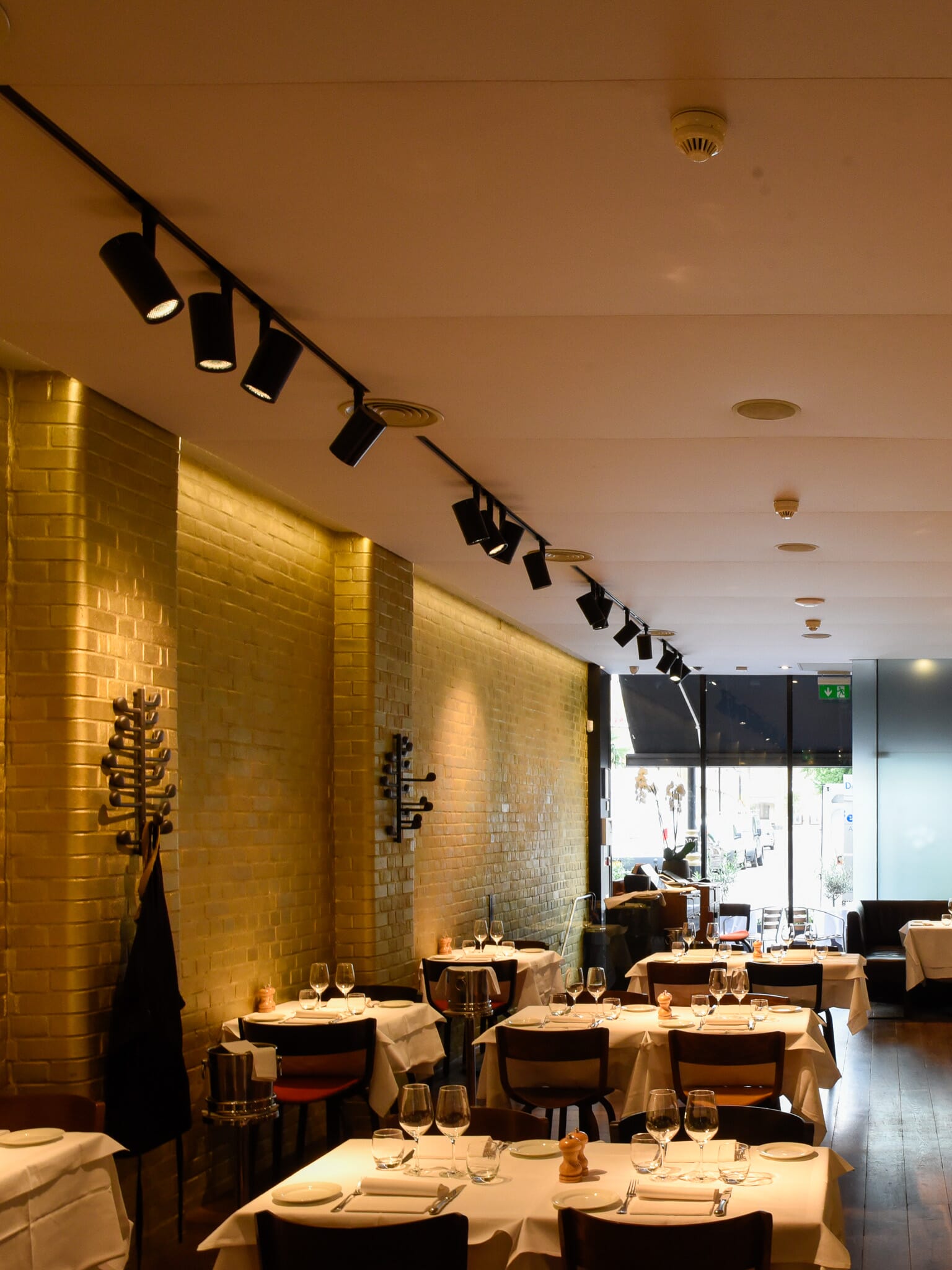 Tenso Ceiling, one of the best acoustic panels for restaurants, installed in a busy restaurant to improve diner comfort.