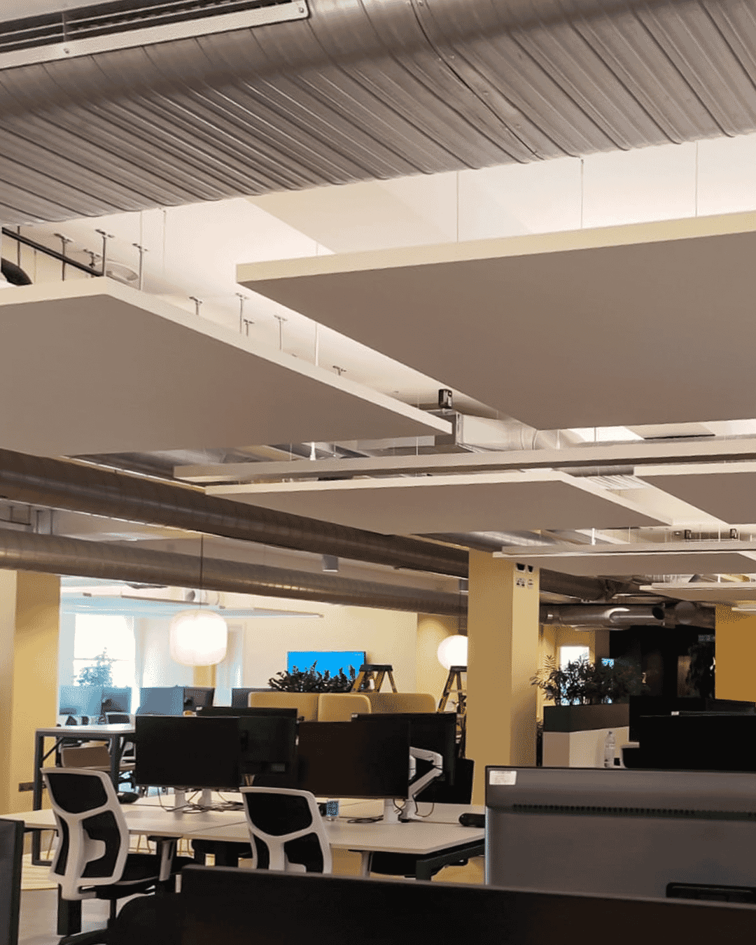 Acoustic panels installed in an open-plan workspace to reduce noise