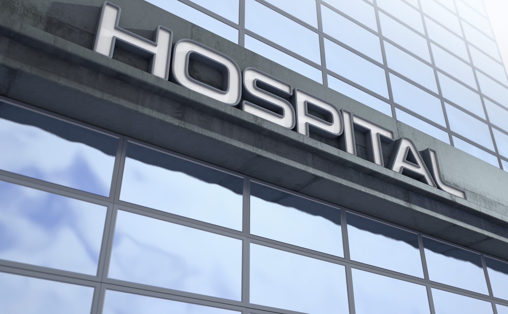 Signage above the entrance to a modern generic hospital building made of exposed concrete and reflective glass in the day time - 3D render